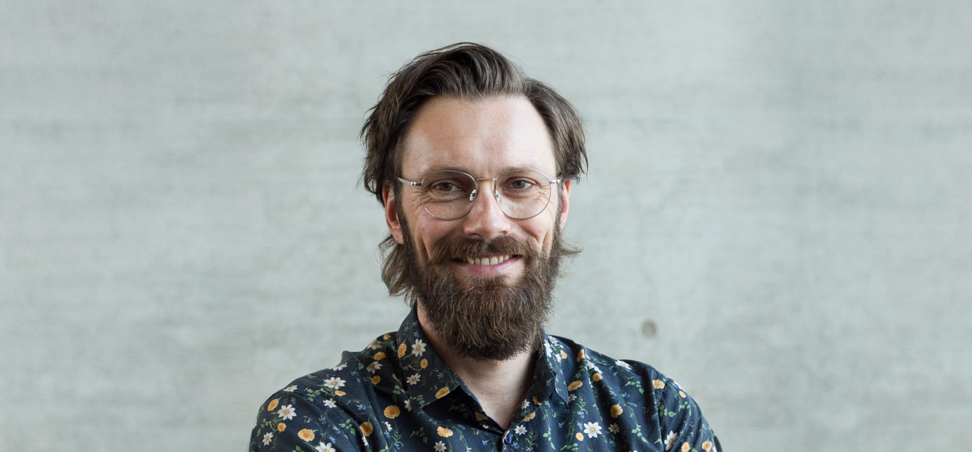 A portrait of Dr. Michael Kirchler against a neutral gray background
