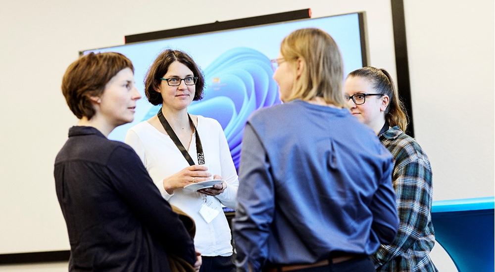 Photo of four people in a discussion group