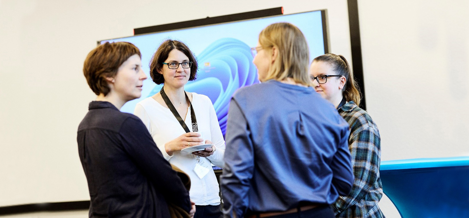Photo of four people in a discussion group