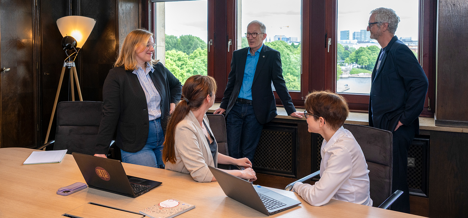 Photo of five people in a discussion group