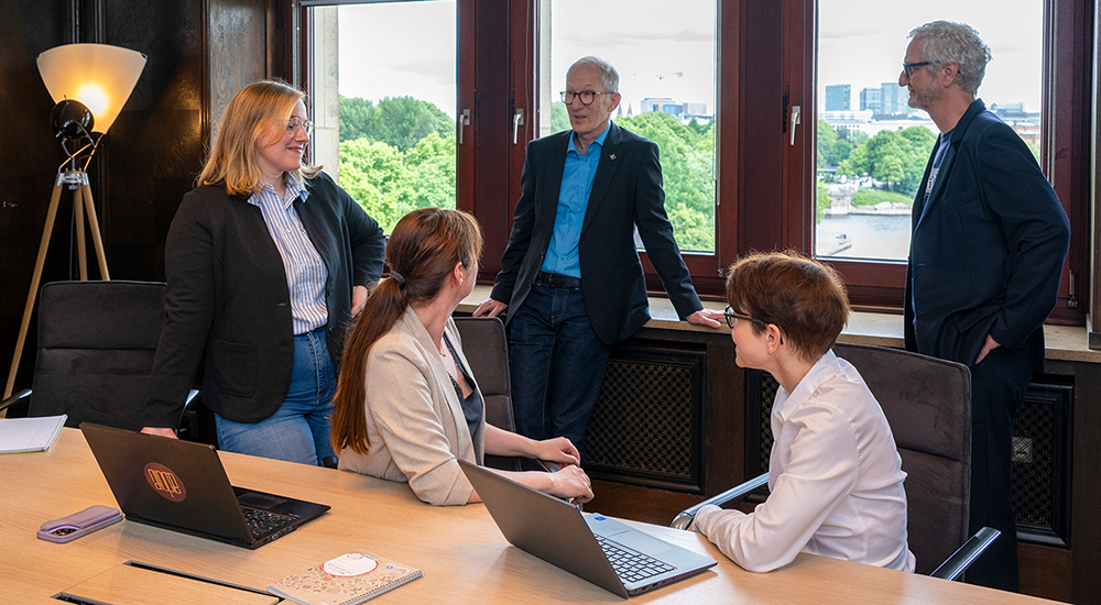 Photo of five people in a discussion group